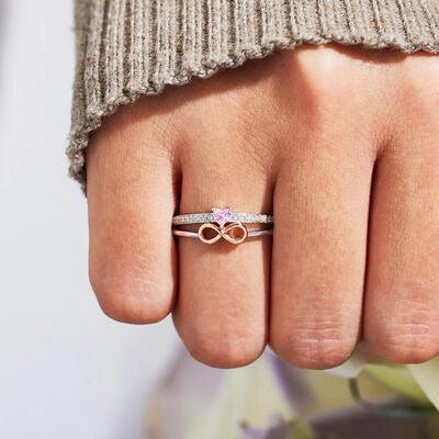 a close up of a person's hand with a ring on it