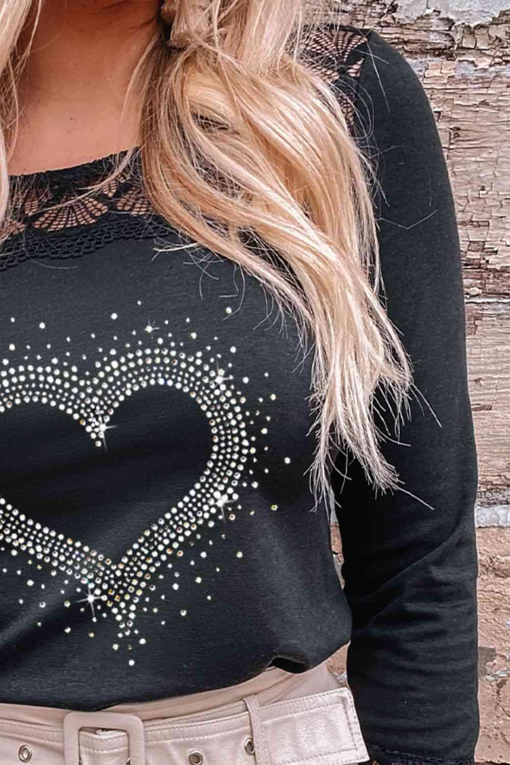 a woman wearing a black shirt with a heart on it