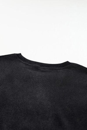 a black t - shirt is shown against a white background