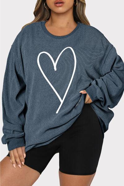 a woman wearing a sweatshirt with a heart drawn on it