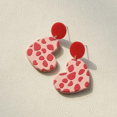 a pair of pink and red heart shaped earrings