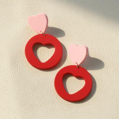 a pair of red and pink heart shaped earrings