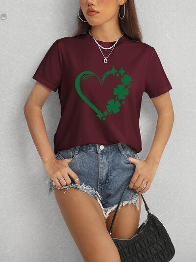 a woman wearing a t - shirt with a shamrock heart on it