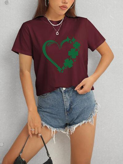 a woman wearing a t - shirt with a shamrock heart on it