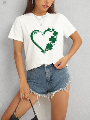 a woman wearing a t - shirt with a shamrock heart on it