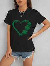 a woman wearing a black shirt with a shamrock heart on it