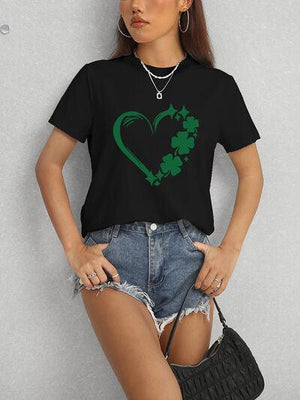 a woman wearing a black t - shirt with a shamrock heart on it