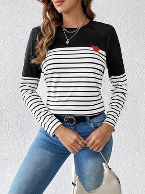 a woman wearing a black and white striped top