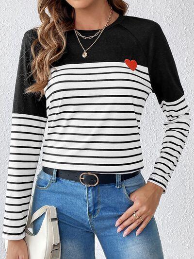 a woman wearing a black and white striped top