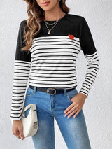 a woman wearing a black and white striped top