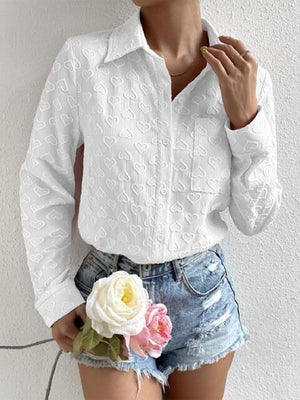 a woman wearing a white shirt and denim shorts