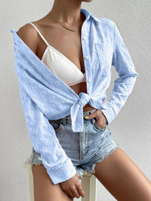 a woman wearing a blue shirt and denim shorts