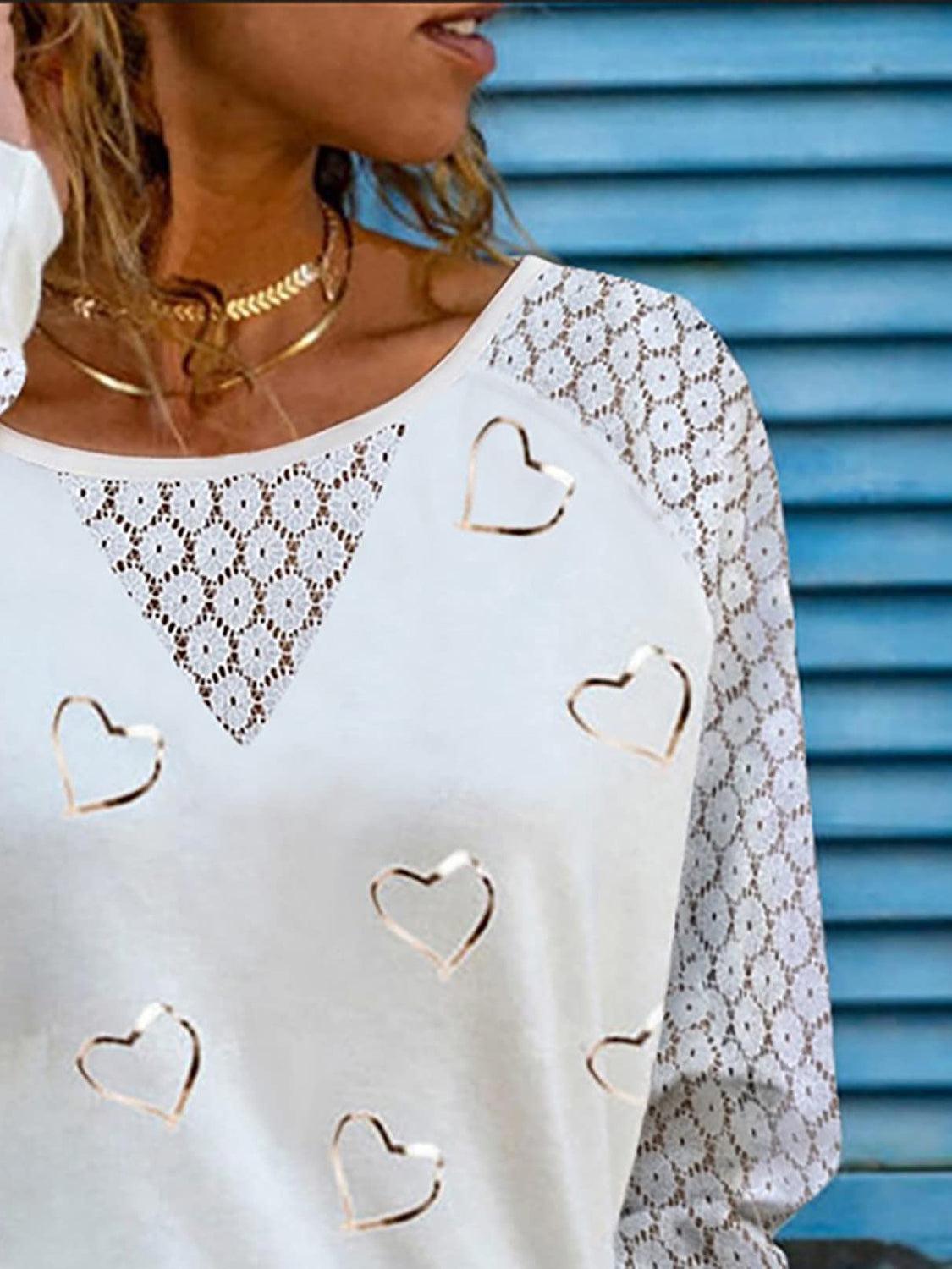 a woman wearing a white top with hearts on it