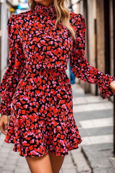 a woman in a red and black dress is walking down the street