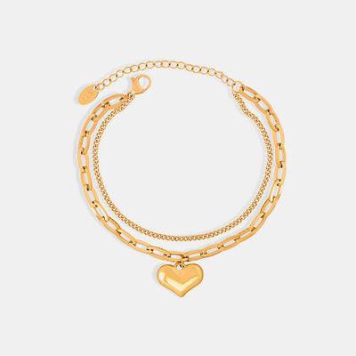 a gold bracelet with a heart charm