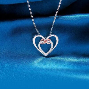 a heart shaped pendant on a chain