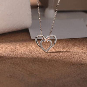 a heart shaped necklace with a diamond accent