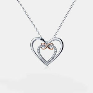 a heart shaped necklace with a diamond accent