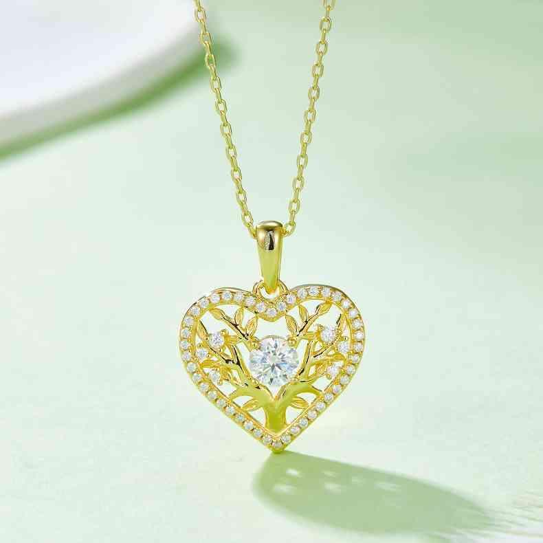 a heart shaped pendant with a diamond center