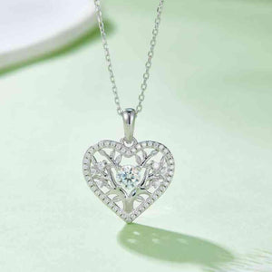 a heart shaped pendant with a diamond center