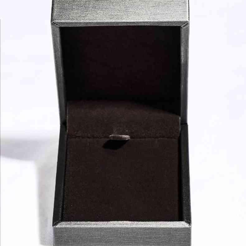 an open box with a ring inside of it