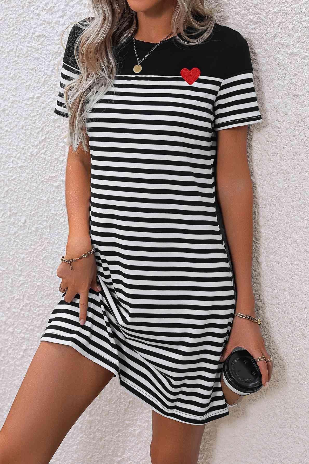 a woman wearing a black and white striped dress