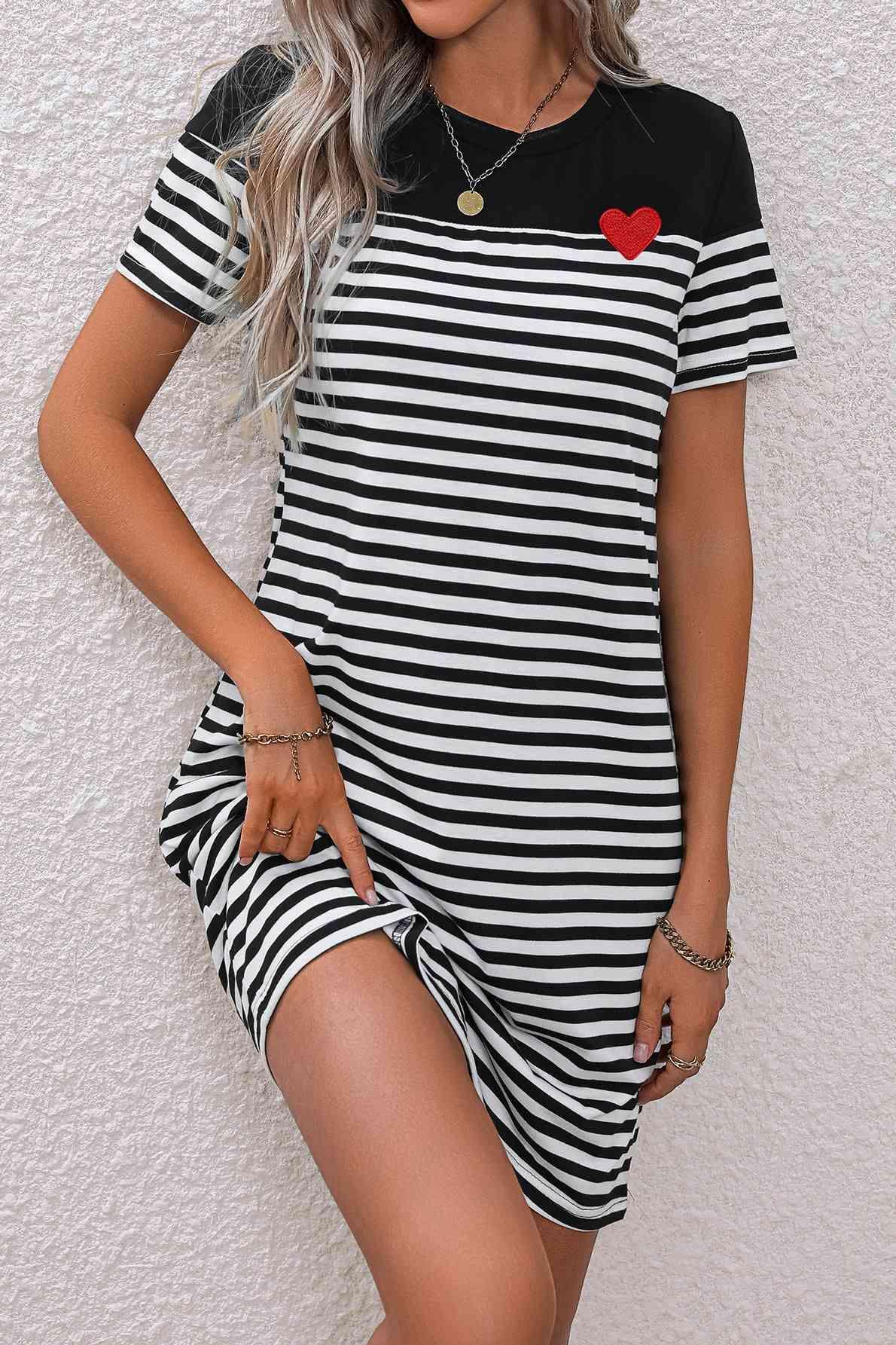 a woman wearing a black and white striped dress