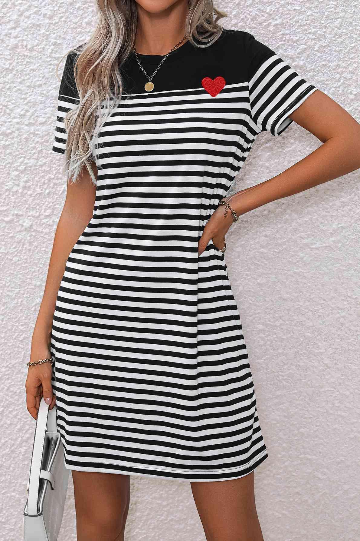 a woman wearing a black and white striped dress