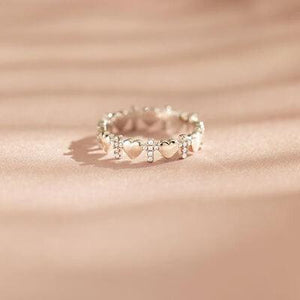 a ring with hearts on it sitting on a table