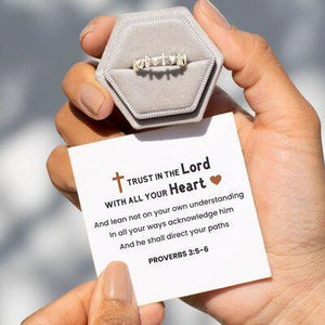 a person holding a card with a ring on it