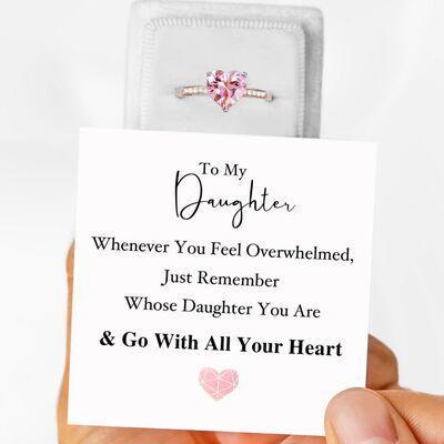 a person holding a card with a ring on it