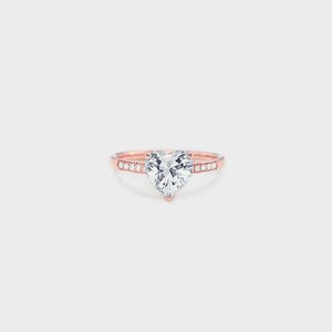 a rose gold ring with a heart shaped diamond