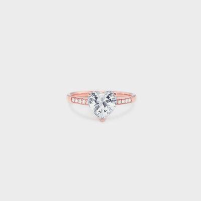 a rose gold ring with a heart shaped diamond