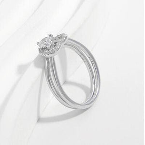 a white gold ring with a pear shaped diamond