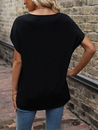 a woman standing in front of a brick wall