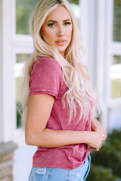 a beautiful blonde woman standing in front of a window