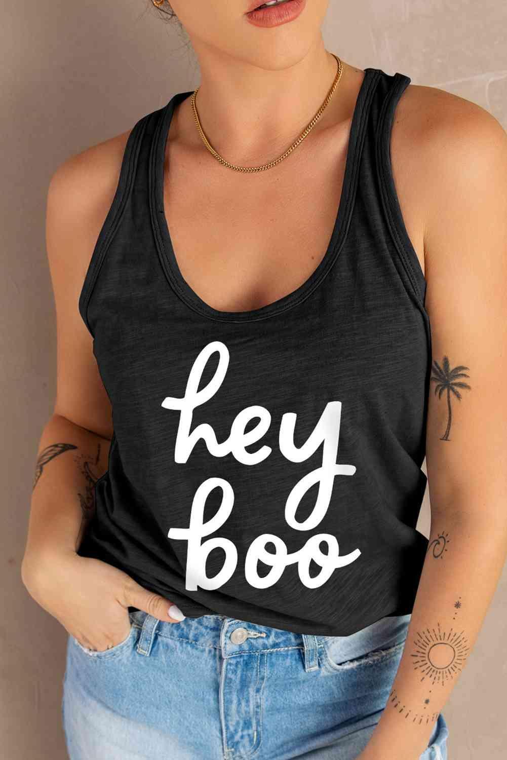a woman wearing a black tank top that says hey boo