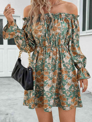 a woman wearing a green floral print dress