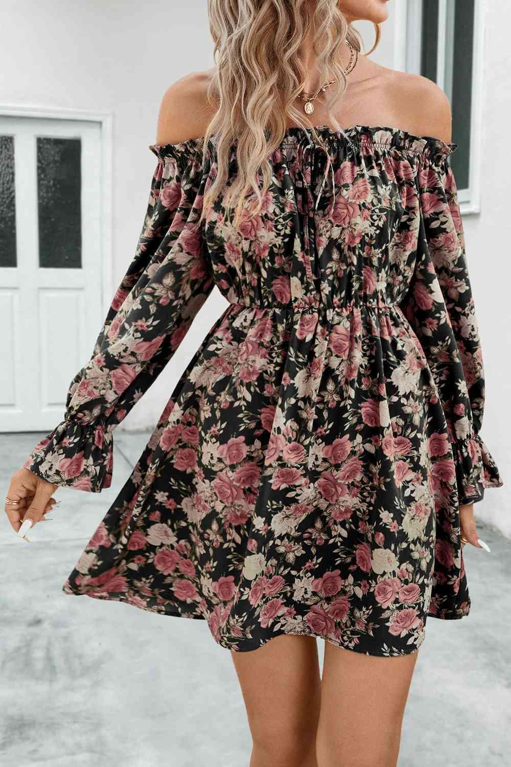 a woman wearing a floral print dress