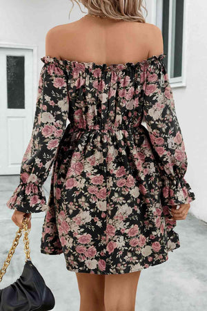 a woman wearing a black floral print dress