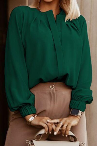 a woman in a green blouse holding a white purse