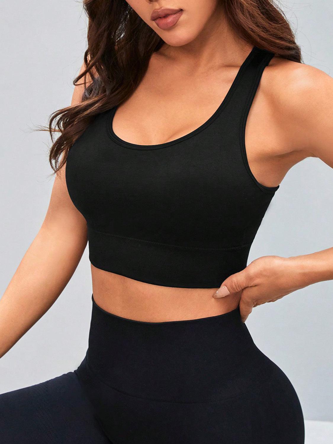 a woman in a black sports bra top and leggings