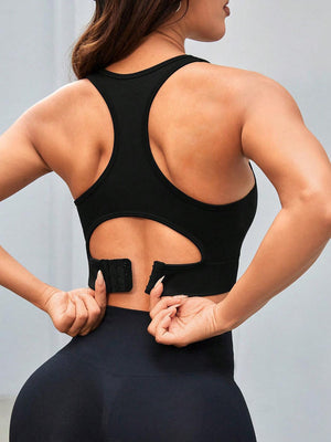 a woman wearing a black sports bra with her hands on her hips