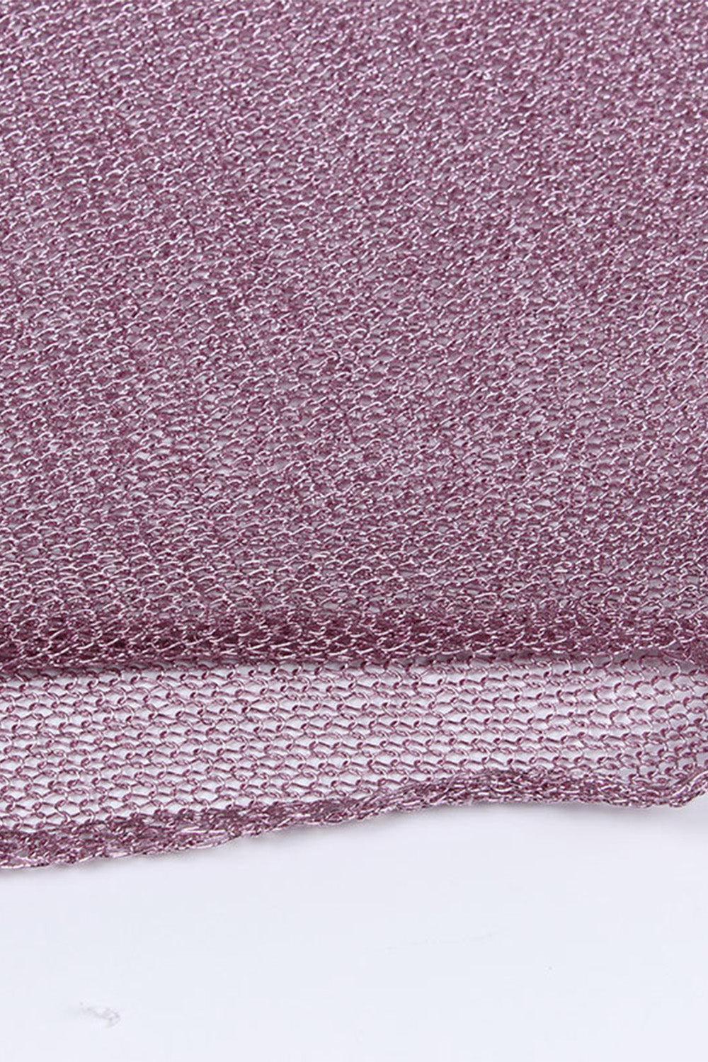 a close up of a purple cloth on a white surface