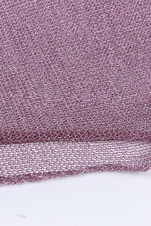 a close up of a purple cloth on a white surface