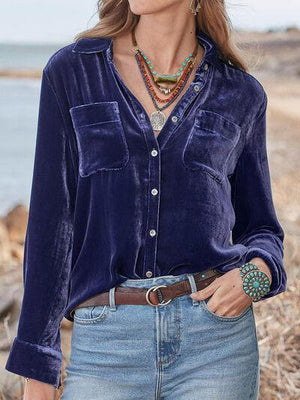 a woman wearing a blue shirt and jeans