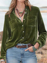 a woman wearing a green shirt and jeans