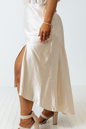 a woman wearing a white skirt and heels