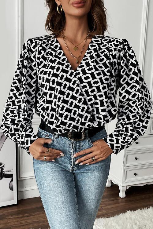 a woman wearing a black and white top and jeans