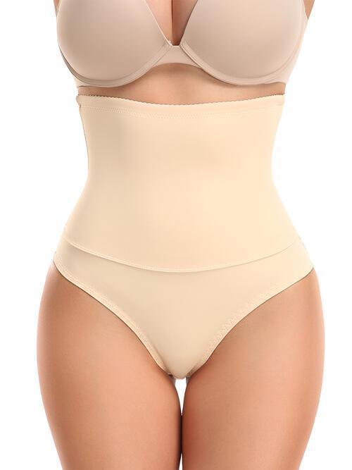 a woman wearing a beige underwiret and panties